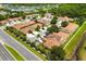 Scenic aerial view of a residential neighborhood near a lake, featuring a mix of homes, greenery, and road networks at 3404 Village Green Ct, St Cloud, FL 34772