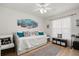 Comfortable bedroom with natural light, stylish decor, and a cozy daybed at 3404 Village Green Ct, St Cloud, FL 34772