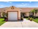Charming single-story home with a well-maintained lawn and two-car garage in a peaceful neighborhood at 3404 Village Green Ct, St Cloud, FL 34772