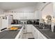 Charming kitchen features white cabinetry, modern appliances, and a convenient island for meal prep at 3404 Village Green Ct, St Cloud, FL 34772