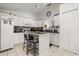 Well-lit kitchen featuring white cabinets, central island and modern appliances at 3404 Village Green Ct, St Cloud, FL 34772