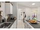 Bright kitchen features sleek countertops, stainless steel appliances, and easy access to the entryway at 3404 Village Green Ct, St Cloud, FL 34772