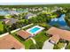 Aerial view of a community pool area with lounge chairs, umbrellas, and well-maintained landscaping at 3404 Village Green Ct, St Cloud, FL 34772