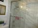 Shower with marble-look tiling and glass doors at 362 White Marsh Cir, Orlando, FL 32824