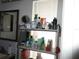 Bright bathroom featuring a shelving unit holding toiletries and a mirror above the sink at 362 White Marsh Cir, Orlando, FL 32824