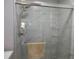 Bathroom with glass enclosed shower and marble tiling at 362 White Marsh Cir, Orlando, FL 32824