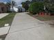 Long driveway leading to a well-kept home with lush greenery at 362 White Marsh Cir, Orlando, FL 32824