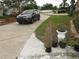 Driveway view features well maintained plants and an up-close view of a parked car at 362 White Marsh Cir, Orlando, FL 32824