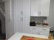 Bright kitchen featuring white cabinets, granite counters, and tile backsplash at 362 White Marsh Cir, Orlando, FL 32824