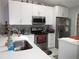 Bright kitchen with stainless steel appliances, white cabinets, and tile backsplash at 362 White Marsh Cir, Orlando, FL 32824