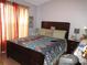 Cozy bedroom featuring warm colors, wood floors, and a large bed at 362 White Marsh Cir, Orlando, FL 32824