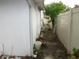 Narrow side yard shows some over growth at 362 White Marsh Cir, Orlando, FL 32824