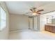 A carpeted bedroom that offers access to the bathroom, complemented by neutral wall colors and a ceiling fan at 403 Broadview Ave, Altamonte Springs, FL 32701