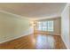 Spacious living room showcasing hardwood floors, a large window, and neutral wall color at 403 Broadview Ave, Altamonte Springs, FL 32701
