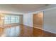 Bright living room featuring hardwood floors, natural light, and classic white trim and mouldings at 403 Broadview Ave, Altamonte Springs, FL 32701