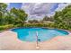 Refreshing in-ground pool surrounded by lush greenery, ideal for outdoor enjoyment and relaxation at 403 Broadview Ave, Altamonte Springs, FL 32701