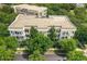 Aerial view of complex surrounded by lush trees, showcasing the building's architecture and setting at 4385 Wardell Pl # 13, Orlando, FL 32814