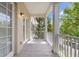 Covered balcony with a view of the neighborhood's lush greenery at 4385 Wardell Pl # 13, Orlando, FL 32814