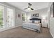 Inviting bedroom with a ceiling fan, neutral tones, and access to a private balcony at 4385 Wardell Pl # 13, Orlando, FL 32814