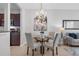 Elegant dining area features a glass-top table, cushioned chairs, and a decorative chandelier at 4385 Wardell Pl # 13, Orlando, FL 32814