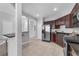 Well-lit kitchen equipped with stainless steel appliances and dark wood cabinets at 4385 Wardell Pl # 13, Orlando, FL 32814