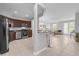 Open kitchen with stainless steel appliances, dark wood cabinets and an adjacent bar area with seating at 4385 Wardell Pl # 13, Orlando, FL 32814