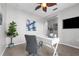 Inviting office with desk, chair, leafy plant, neutral color palette, and a ceiling fan at 4385 Wardell Pl # 13, Orlando, FL 32814