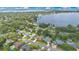 Stunning aerial view of a lakeside community featuring private pools, lush greenery and beautiful scenery at 4390 Carolwood St, Orlando, FL 32812