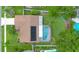 Aerial view of backyard featuring a screened pool, patio, and solar panels for energy efficiency at 4390 Carolwood St, Orlando, FL 32812