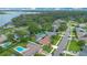 Scenic aerial shot of a residential neighborhood with backyard pools near a large lake and lush trees at 4390 Carolwood St, Orlando, FL 32812
