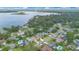 Breathtaking aerial view of homes with pools nestled amidst lush greenery near a stunning lake at 4390 Carolwood St, Orlando, FL 32812