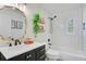 Updated bathroom features black fixtures, a white subway tile shower, and a modern vanity with gold hardware at 4390 Carolwood St, Orlando, FL 32812