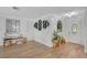 Inviting foyer with wood-look floors, decorative shelving, and a stylish front door at 4390 Carolwood St, Orlando, FL 32812