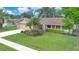 Charming single-Gathering home with well-manicured lawn, mature landscaping, and attached two-car garage at 4390 Carolwood St, Orlando, FL 32812