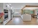 Modern kitchen featuring stainless steel appliances, white cabinets, and a large island with counter seating at 4390 Carolwood St, Orlando, FL 32812
