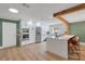 Updated kitchen with stainless steel appliances, white cabinetry, and a large center island with seating at 4390 Carolwood St, Orlando, FL 32812