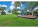 Community playground with swings and a slide provides recreation in a grassy area with mature trees at 4390 Carolwood St, Orlando, FL 32812