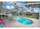 Screened-in pool area with a brick patio features a sparkling pool, lounge seating, and a fenced yard at 4390 Carolwood St, Orlando, FL 32812