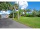 Picturesque waterfront with dock access and lush tropical landscaping for a serene outdoor experience at 4390 Carolwood St, Orlando, FL 32812