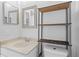 Functional bathroom featuring a sink with a mirror and a shelving unit above the toilet at 446 Arkansas Ct, Poinciana, FL 34759