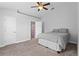 Cozy bedroom with soft carpet, ceiling fan, and ensuite bath at 446 Arkansas Ct, Poinciana, FL 34759