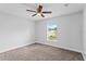 Simple bedroom featuring carpet flooring, a ceiling fan, and a bright window view at 446 Arkansas Ct, Poinciana, FL 34759