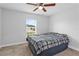 Bright bedroom with a comfortable bed and a window view of the outdoors at 446 Arkansas Ct, Poinciana, FL 34759