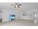 Open-concept living room featuring vaulted ceilings and a stylish ceiling fan with tile flooring at 446 Arkansas Ct, Poinciana, FL 34759