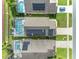 Birds eye view showcases residences equipped with solar panels and screened-in pools in a tidy neighborhood layout at 4533 Oakbrook Ct, Kissimmee, FL 34746