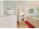 Bathroom with a glass door shower, double sinks, and a view into the bedroom at 4533 Oakbrook Ct, Kissimmee, FL 34746
