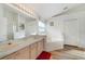 Bright bathroom with double sinks, soaking tub, and a separate shower at 4533 Oakbrook Ct, Kissimmee, FL 34746