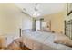 Relaxing bedroom with light yellow walls, white ceiling fan, closet, and simple decor create a peaceful retreat at 4533 Oakbrook Ct, Kissimmee, FL 34746