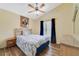 Cozy bedroom with a ceiling fan, a comfortable bed, and bright natural light from the window at 4533 Oakbrook Ct, Kissimmee, FL 34746