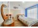 Cheerful bedroom with laminate floors, bright blue accent wall, and lots of natural light at 4533 Oakbrook Ct, Kissimmee, FL 34746